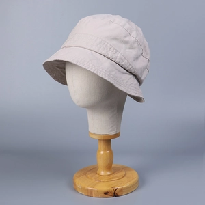 Minimalist light grey washed cotton bucket hat for women on a professional display stand