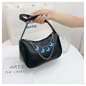 Detail of black crescent shoulder bag with silver chain and blue gradient butterflies