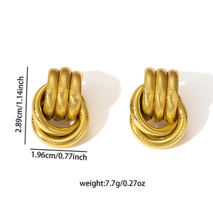 Detailed size view of gold knot earrings measuring 2.89cm by 1.96cm and weighing 7.7g