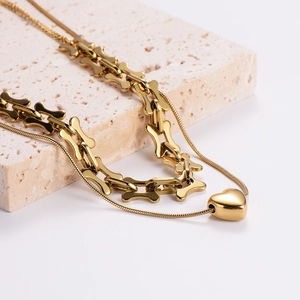 Double-layered golden chain necklace featuring a chunky link and heart pendant