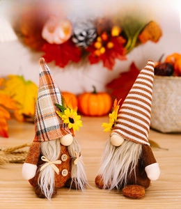 Detail of fall gnomes with sunflowers, maple leaves, and buttons on a seasonal backdrop