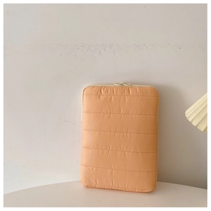 Quilted light orange laptop sleeve case with soft down cotton texture and zipper detail