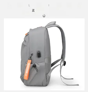 Waterproof laptop backpack side view featuring integrated USB charging port and orange accents