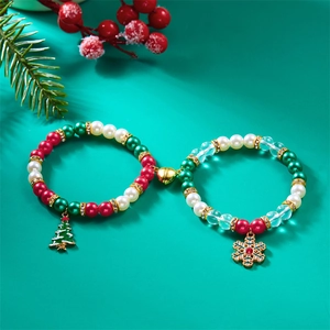 Close-up of magnetic Christmas bracelets with heart clasp, tree and snowflake charms