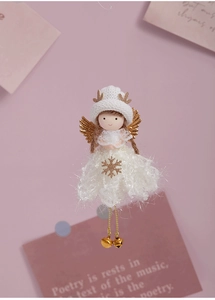 Detail of plush Christmas angel ornament with golden antlers and snowflake dress