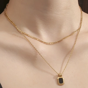 Double-layered gold titanium steel necklace featuring a black rectangular pendant
