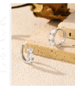 Detailed view of S925 sterling silver hoop earrings with three inlaid moissanite stones
