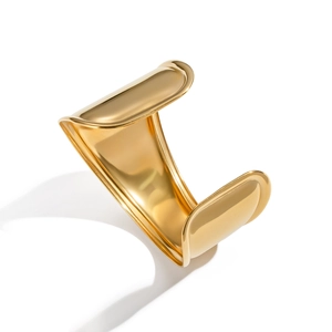 Minimalist wide wave cuff bangle with polished 18K gold plating on a white background