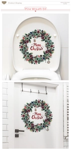 Detail of a Merry Christmas pine wreath decal applied on a door and toilet seat