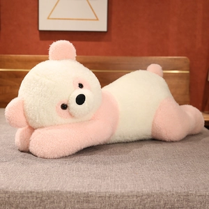 Gros plan d'un ours en peluche rose et blanc en position couchée sur un lit texturé