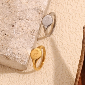Detail shot of 18K gold and silver stainless steel rings with LTJ logo engraving