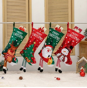 Set of 4 festive Christmas stockings with reindeer and Santa motifs hanging on a stand