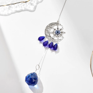 Silver celestial sun and moon ornament with hanging blue crystal pendants and ball