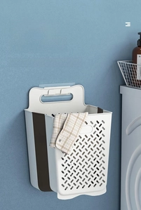 Close-up of foldable laundry basket showing gray TPE material and wall-mounted handle design