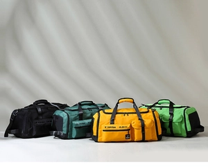 Close-up of four colorful duffle bags in black, green, yellow, and neon green fabric