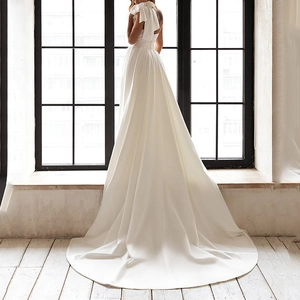 Elegant white satin wedding dress with open back bow and long lace trailing train