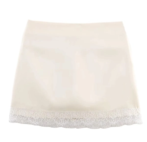 Close-up of elegant cream fabric with delicate white lace trim on the hemline