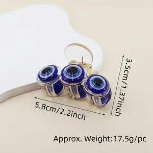 Detail view of the evil eye hair claw clip with dimensions 5.8cm length and 17.5g weight
