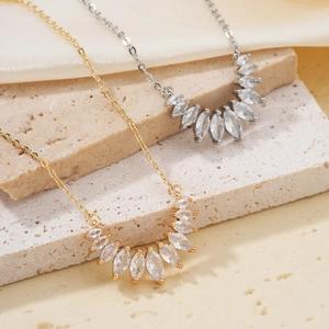 Elegant gold and silver marquise zircon teardrop necklace set on silk background