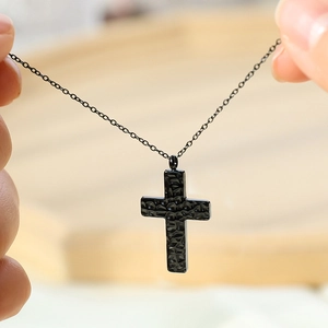 Minimalist black stainless steel cross necklace with a unique hammered texture finish
