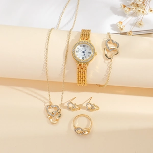 Close-up of gold quartz watch set with rhinestone heart necklace earrings and ring