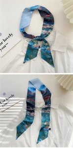 Detailed view of an oil painting style silk scarf tied on a white shirt collar