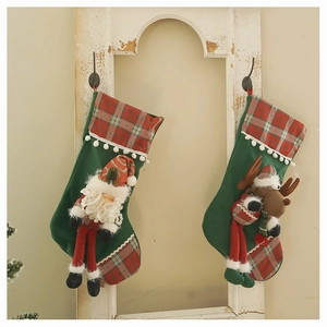 Detail of plush Christmas stockings with 3D Santa and Reindeer on rustic window