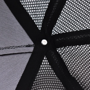 Detailed macro view of internal reinforced stitching and mesh panels on trucker hat