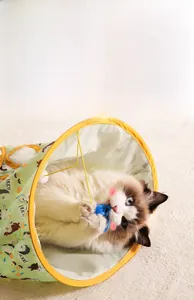 Detail of a green cat tunnel featuring animal prints and a hanging plush mouse toy