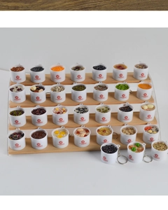 Detailed tiered display of miniature porridge keychain charms with realistic food models