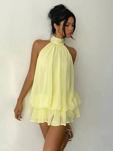 Detail of light yellow halter chiffon mini dress with layered ruffles for vacation