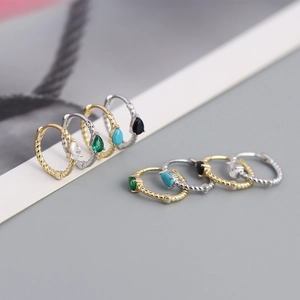 Detailed close-up of twisted S925 silver hoop earrings with colorful pear-cut gemstones