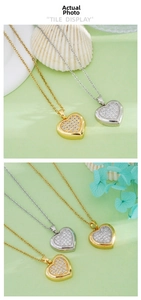 Detail of heart pendant necklaces in gold and silver with shimmering pavé set zircons