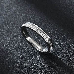 Silver stainless steel couple ring with full square-cut zircon stones on a dark background
