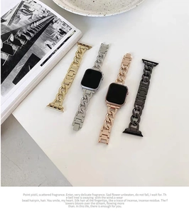 Detail of four chunky metal Cuban chain watch bands in gold, silver, black, and rose gold