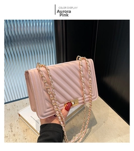 Detail of aurora pink chevron quilted crossbody bag with gold chain and turn lock