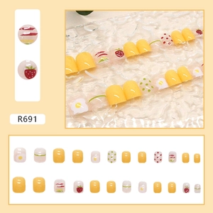 Close-up of R691 press-on nails set with strawberry and poached egg patterns