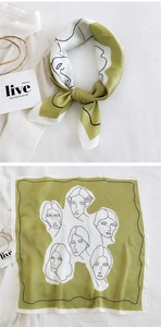 Detail of silk-feel scarf with green-white splicing and abstract face art pattern