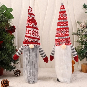 Close-up of festive Christmas gnome wine bottle covers with knitted hats and plush beards