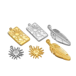 Set of 6 gold and silver stainless steel pendants with sun and feather designs