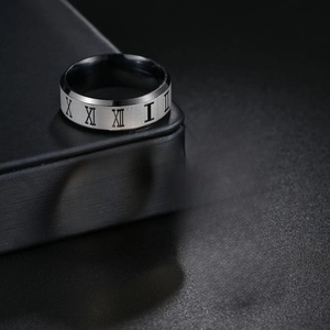 Macro detail of Roman numeral engraving on black titanium steel rings for men