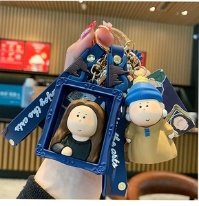 Close-up of cute cartoon art keychains featuring Mona Lisa and Girl with a Pearl Earring