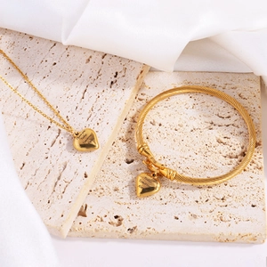 Golden heart jewelry set with engraved Today Tomorrow Always on textured stone