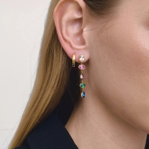 Detail of gold hoop and five-color cubic zirconia fringe earrings on female model