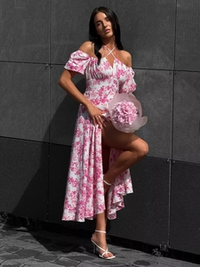 Detail of floral off-shoulder maxi dress featuring high slit and halter neck tie