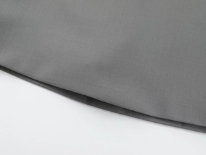 Detailed macro view of the grey woven fabric texture on a high-quality A-line mini skirt