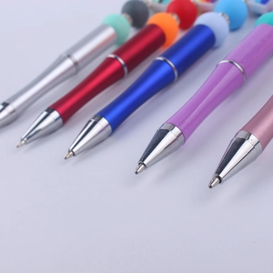DIY colorful beaded pens in metallic silver red blue purple and pink on white background