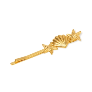Detail shot of golden metal hair clip featuring starfish and shell designs on white background