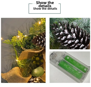 Detail of light-up pine cone wreath with LED warm lights and battery pack