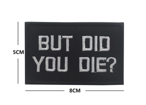 Detail showing 8x5cm But Did You Die tactical morale patch with white embroidery